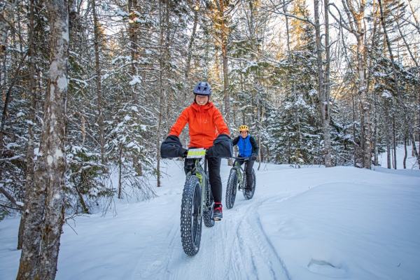 Duo on fat bikes on winter trail