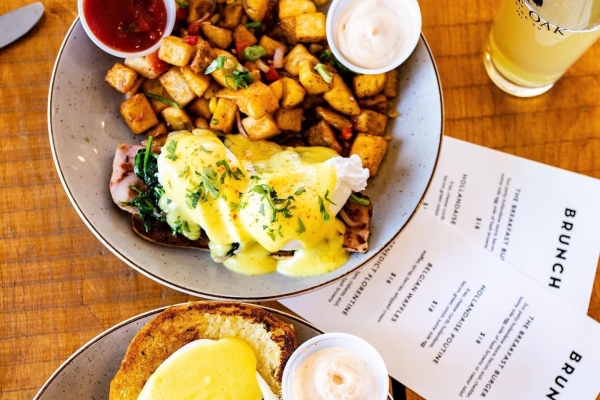 Overhead view of plated brunch menu items with menu in view