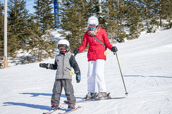 Child and adult on alpine skis at Brookvale