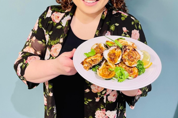 Ilona Daniel holding a plat of baked oysters