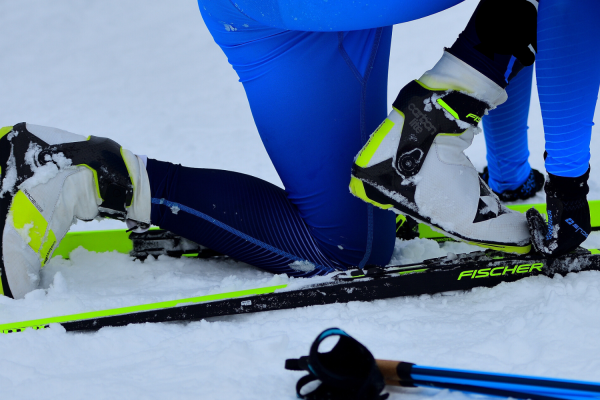 Nordic skier putting boots in skis