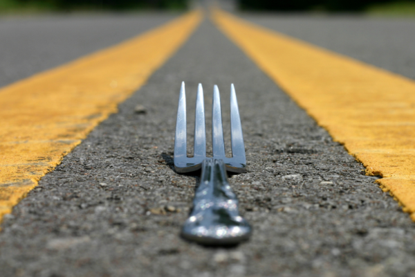 Stock image of fork between yellow lines of a road