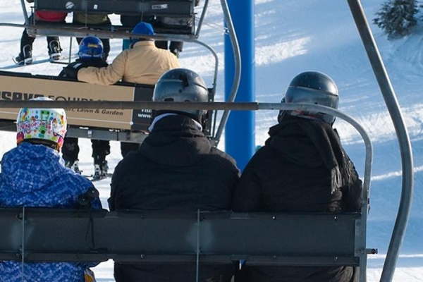 4 people on a chair lift