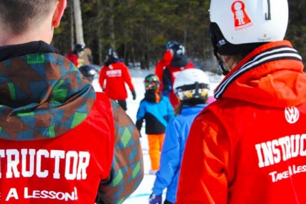 Two instructors looking over group