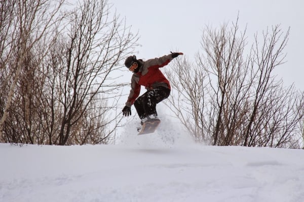 Snowboarder takes flight on hill