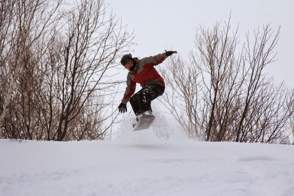 Snowboarder takes flight on hill