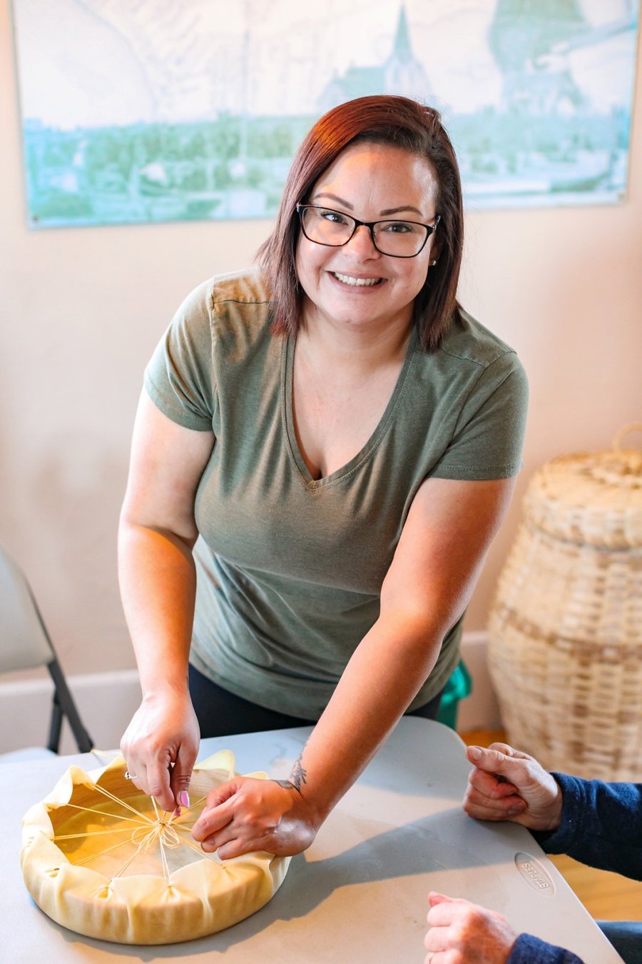 Woman from Lennox Island demonstrates how to tie a hand drum