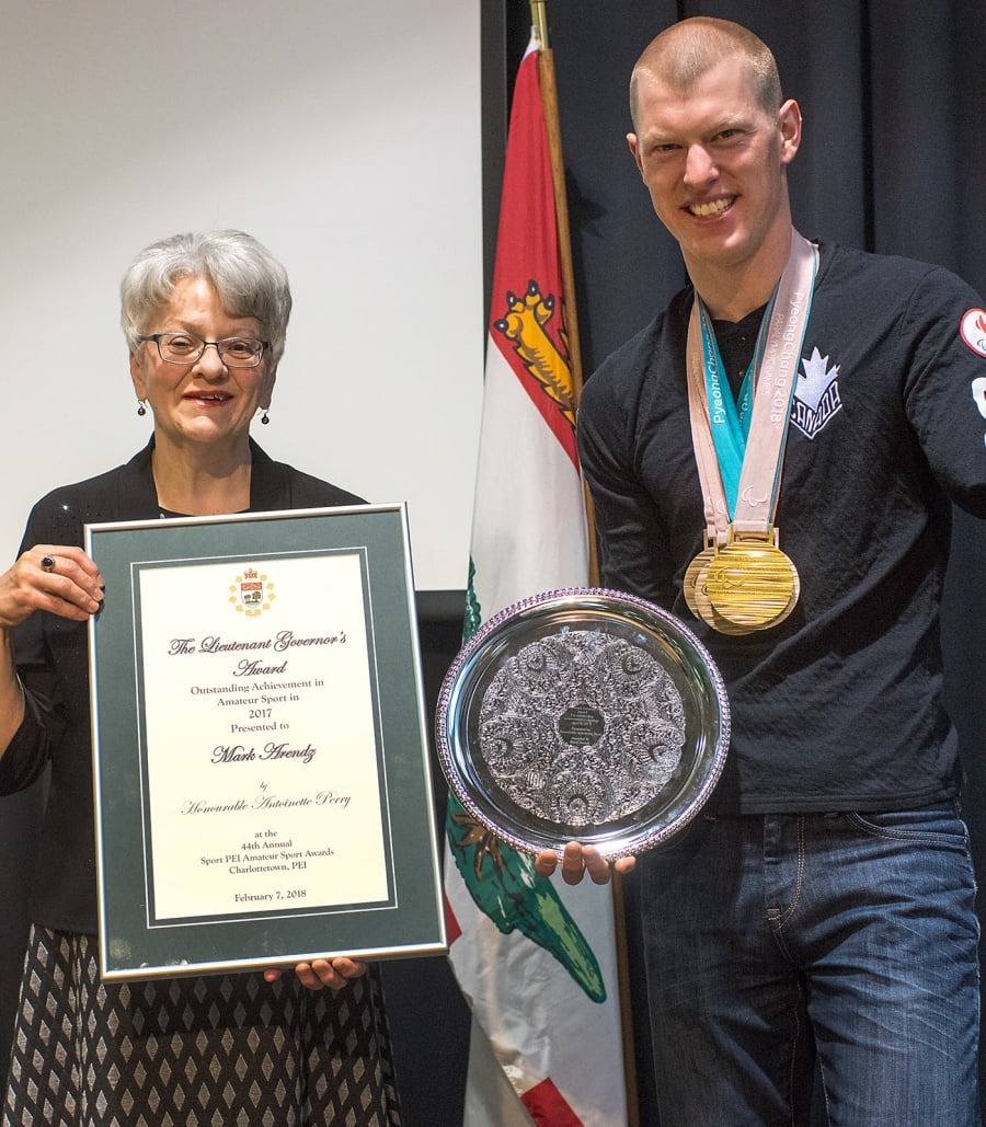 The Honourable Antoinette Perry, Lieutenant Governor of Prince Edward Island, presents an award to Mark Arendz at a ceremony in 2018