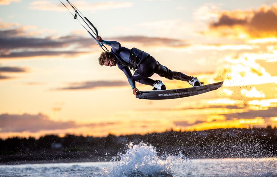 Kiteboarder gets air at sunset