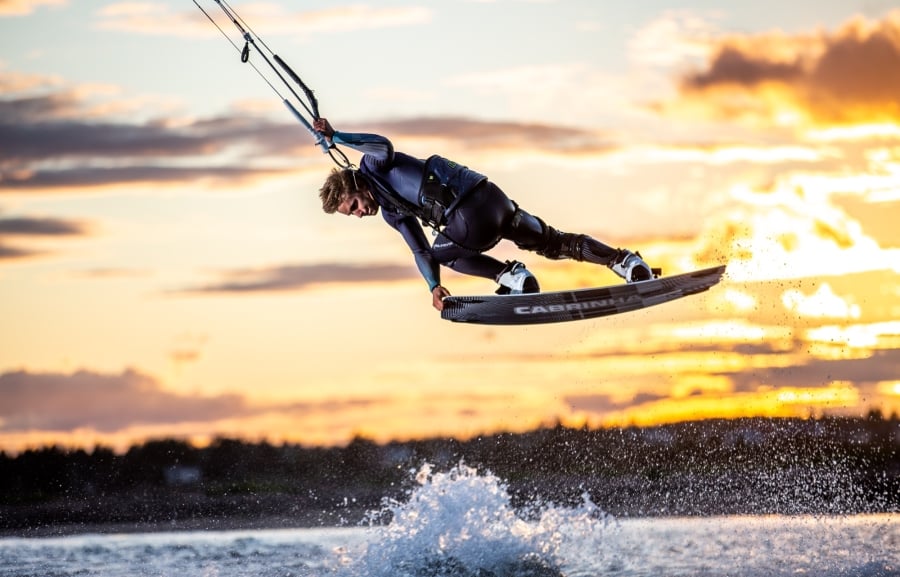 Kiteboarder gets air at sunset