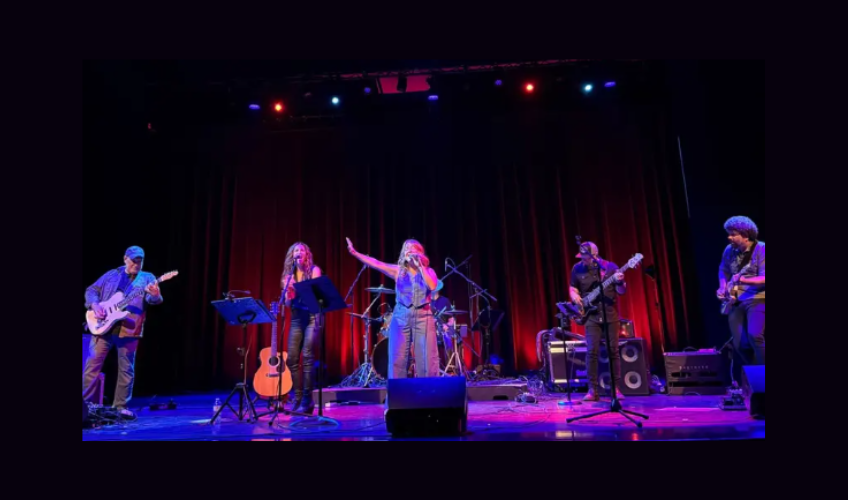 Joanie Pickens and her band perform on stage