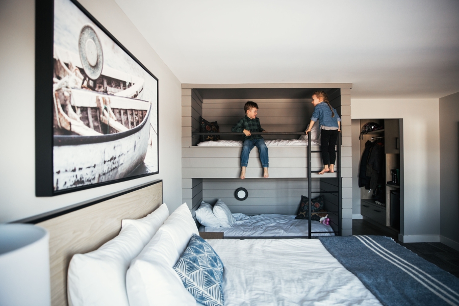 Children climbing into bunk in Mill River Resort guest room