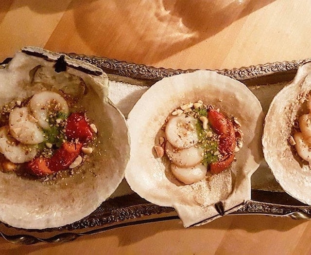 Scallop appetizer served on scallop shells