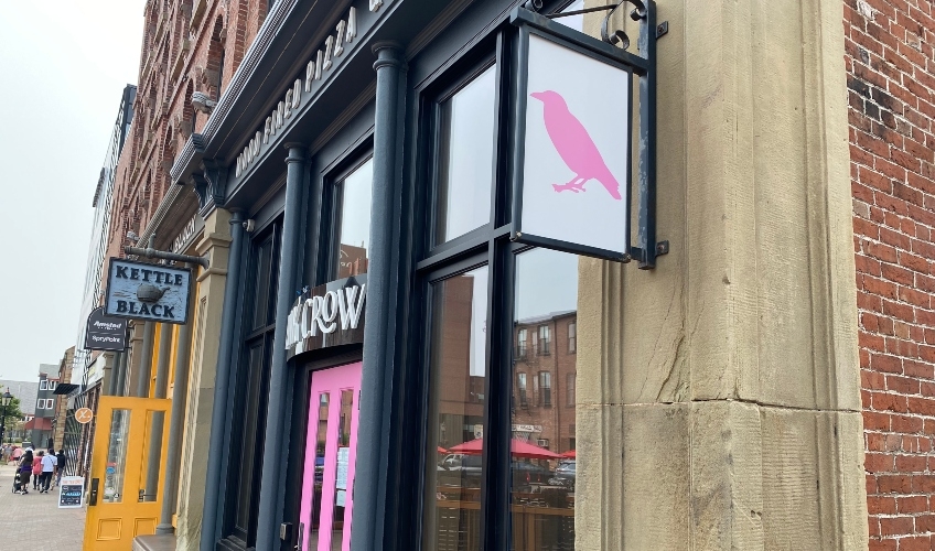 View of front entrance, a pink door, at Pink Crow