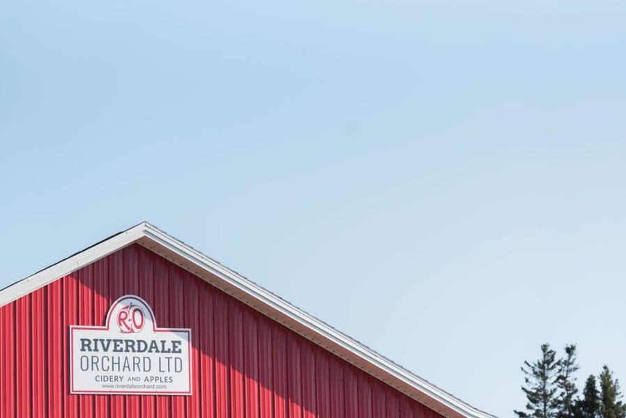 Peak of red building at Image of Riverdale Cidery