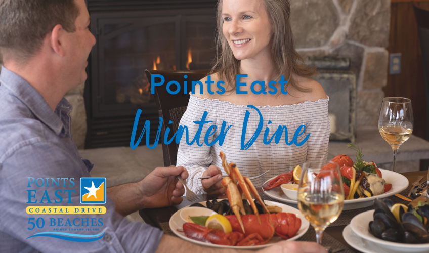 Couple enjoying a lobster dinner in front of fireplace with text "Points East Winter Dine"