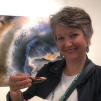 Image of Verna Lynne Weeks holding an oyster and standing in front of Oyster Art