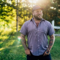 Portrait image of Al Douglas standing in front of trees