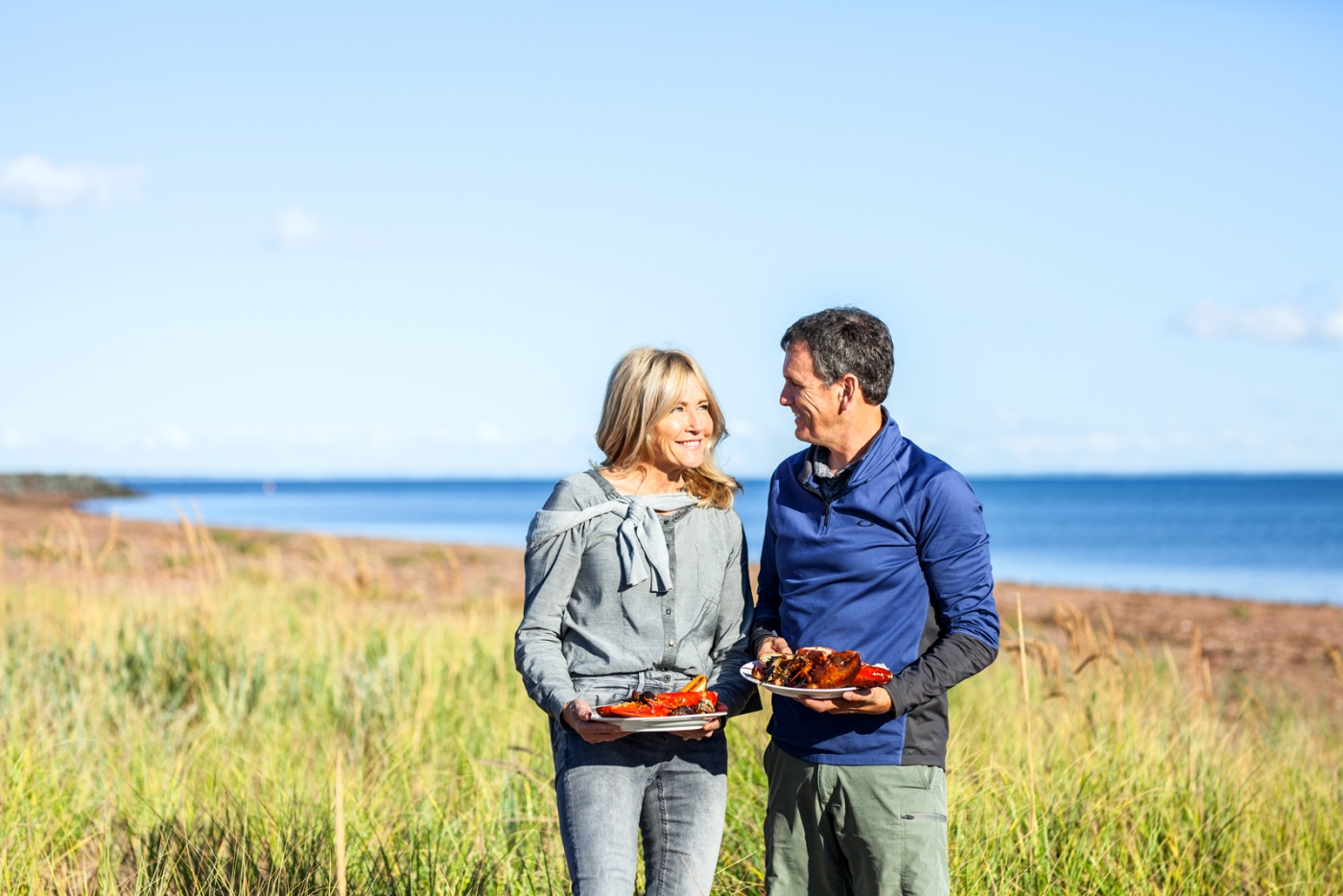 Couple on a beach enjoying lobster 