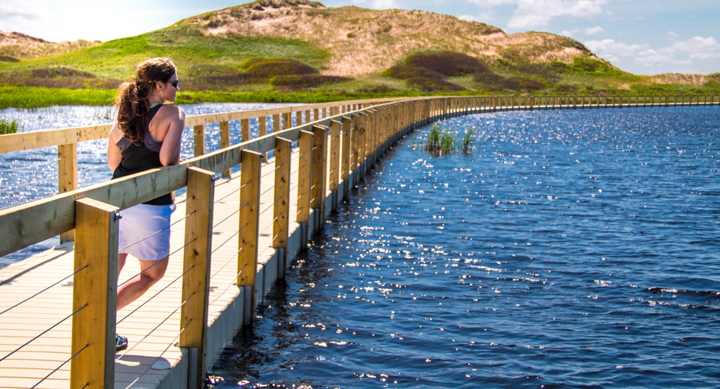 Greenwich, PEI National Park, boardwalk, water, hills, woman Greenwich, PEI National Park, boardwalk, water, hills, woman