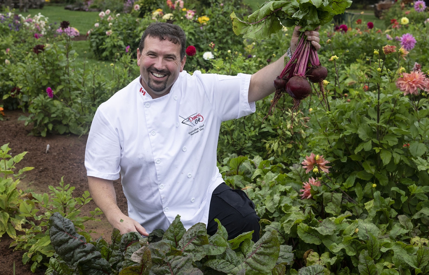 Chef Norman Day holding beets in garden