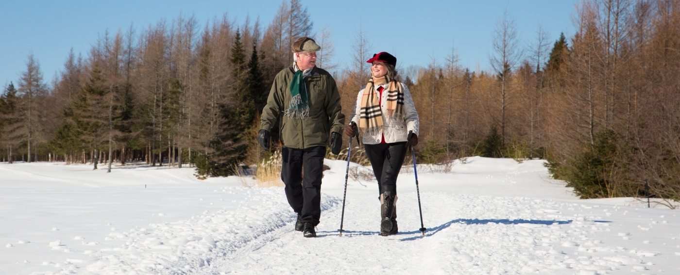 Man and woman walk trails at Brudenell-Dundarave Golf Course in winter