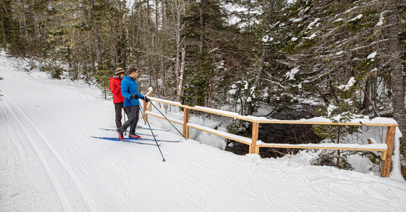 Couple cross country skiing at Souris Strider Ski Club