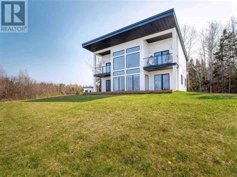 179 Donaldston Road large white cottage with a full bank of windows on front
