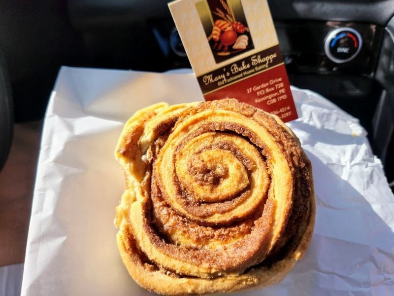 Cinnamon roll pictured with business card in car