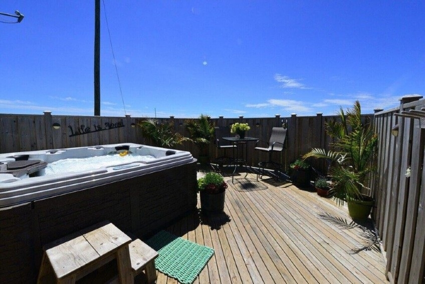 Outdoor hot tub on deck with privacy railings