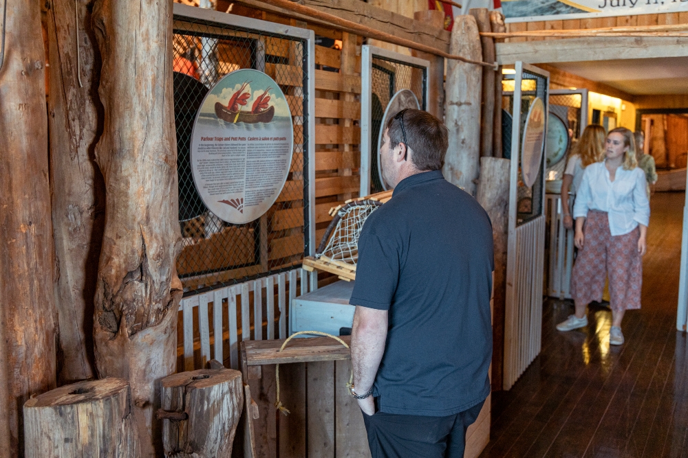 Two people pictured inside Basin Head Fisheries Museum looking at displays