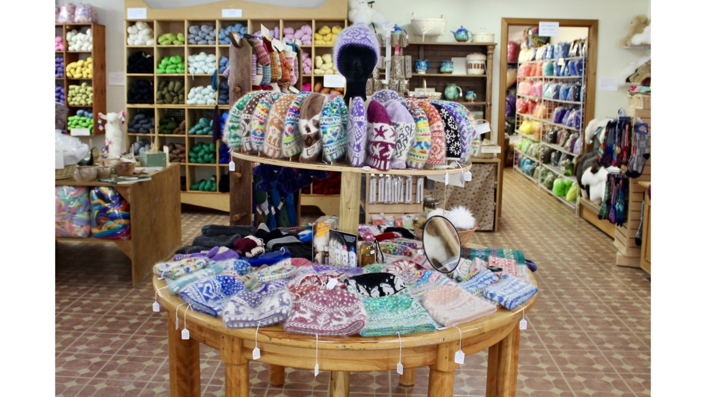 Inside gift shop display of woolen knit products and yarns