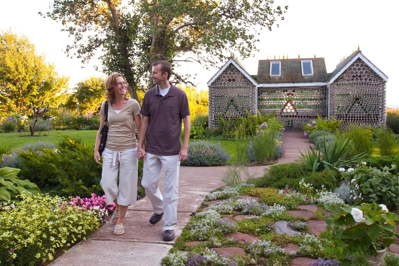 Couple walking through gardens at the Bottle Houses