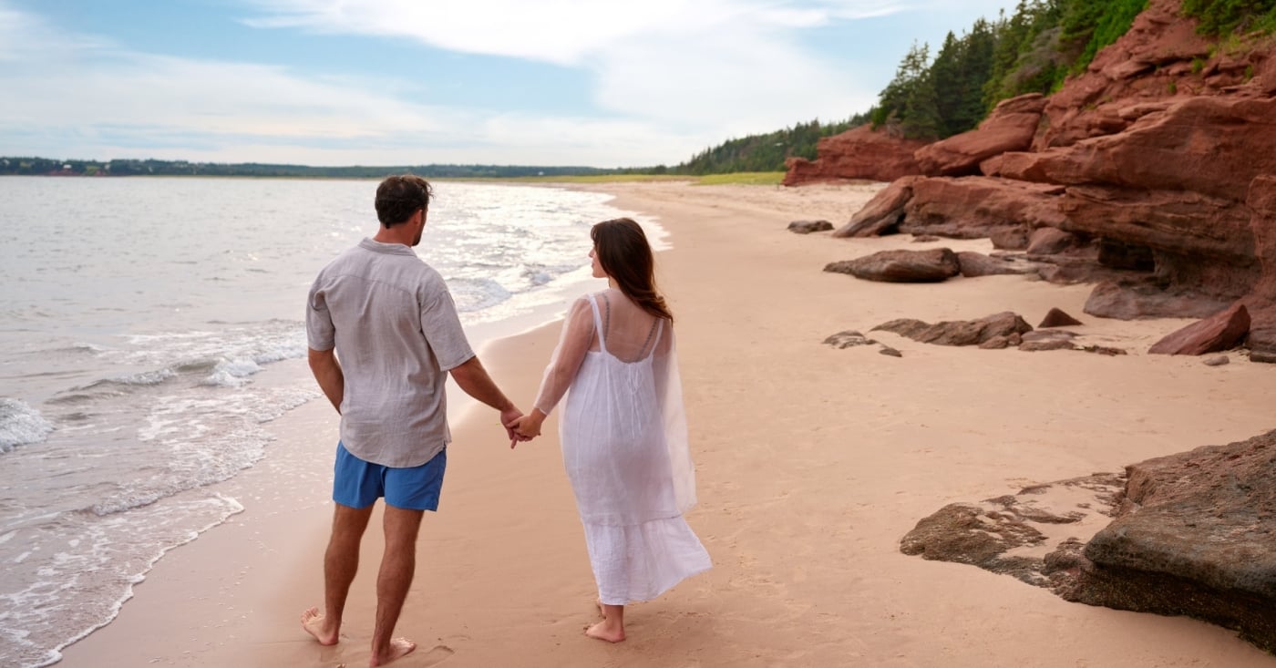 Couple walk hand in hand at Red Point Provincial Park