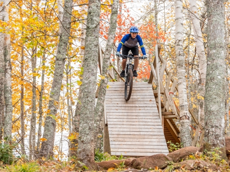Brookvale Nordic Park, PEI Cyclist comes down ramp on the Dark Side Trail at Brookvale