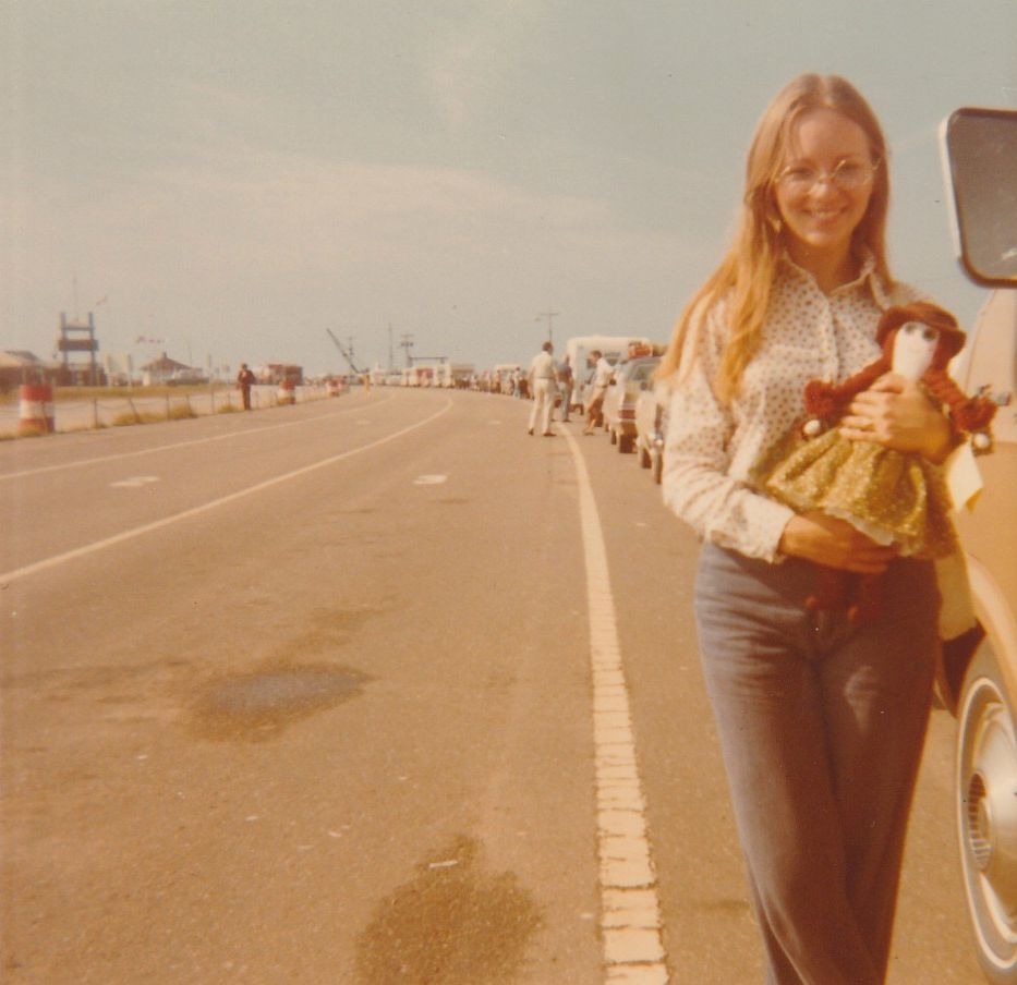 Charlene Belsher holds doll while waiting in line at Wood Islands ferry, 1974