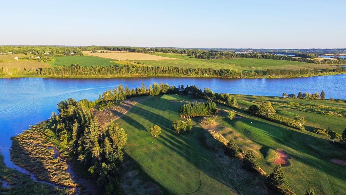 Aerial view of Clyde River Golf Course and river under sunny skies