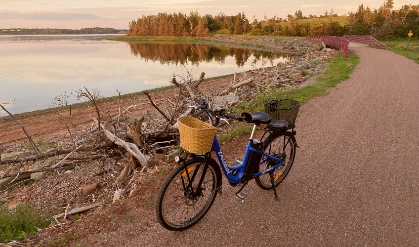 View of Confederation Trail with e-bike near St. Peters