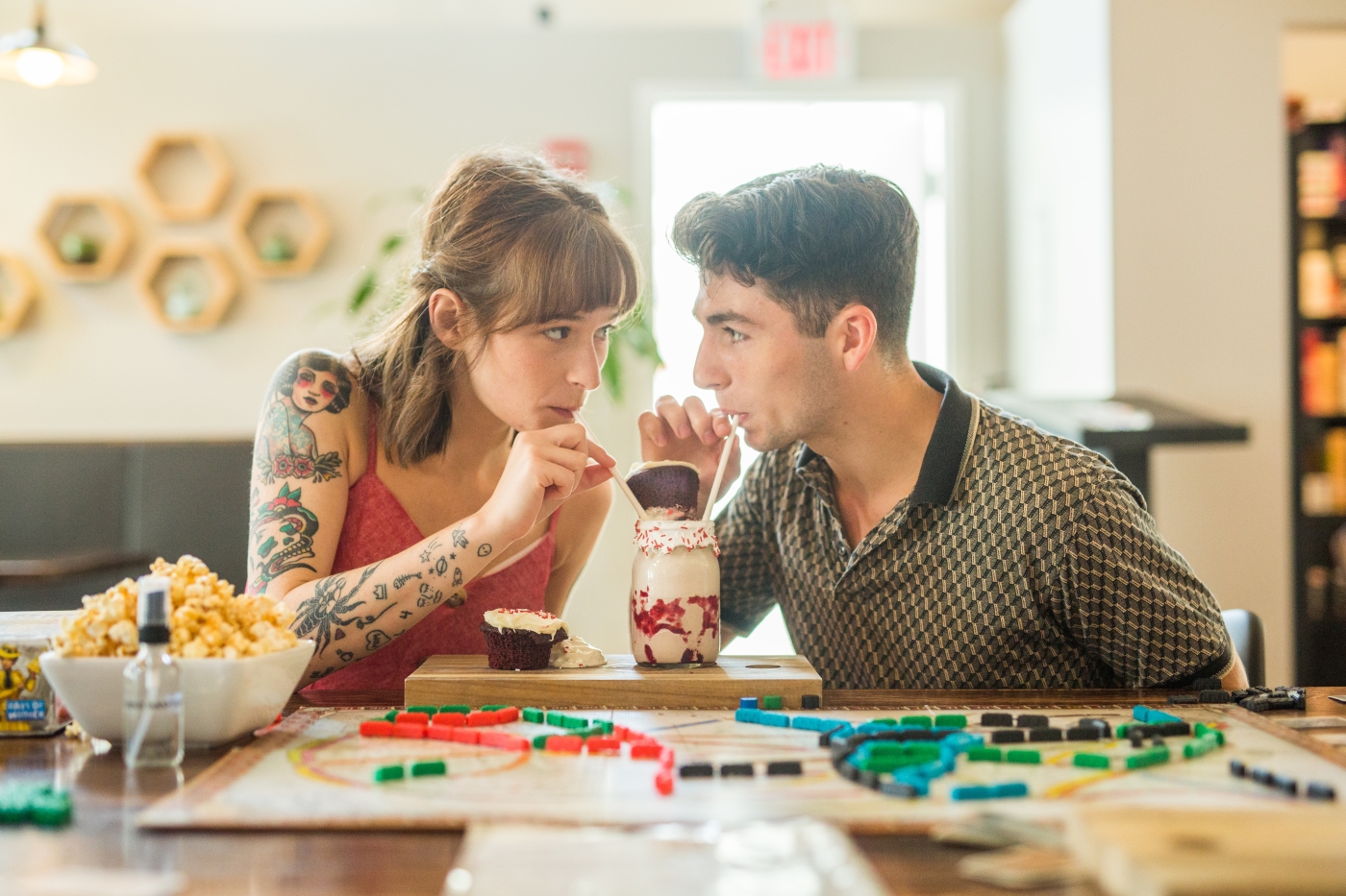 Couple share a milkshare at Hive and Hollow Board Game Cafe