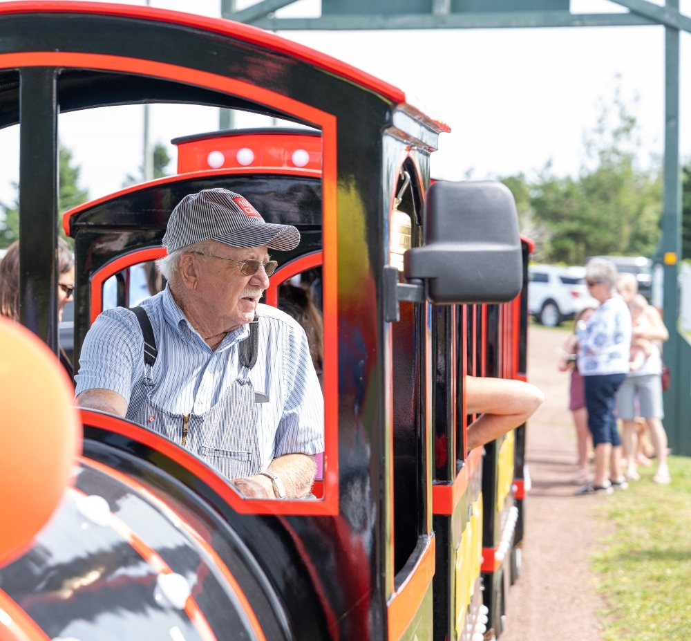 Elmira Railway Museum, PEI Conductor driving mini train at Elmira Railway Museum, PEI