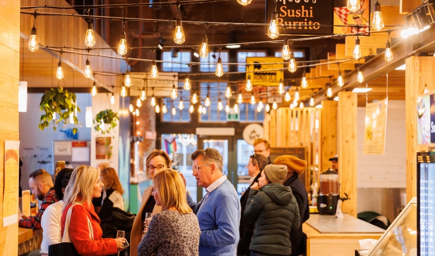 Founders Food Hall & Market, PEI Interior view of Founders Food Hall & Market with groups of people mingling