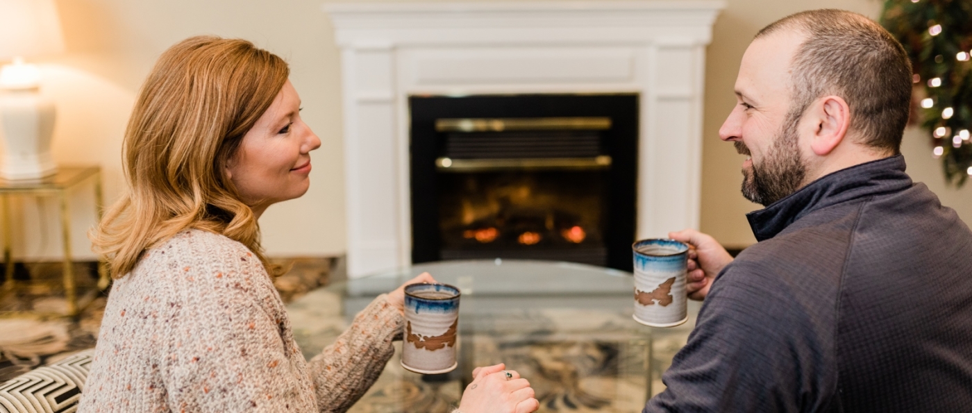 Couple in front of fireplace in hotel room