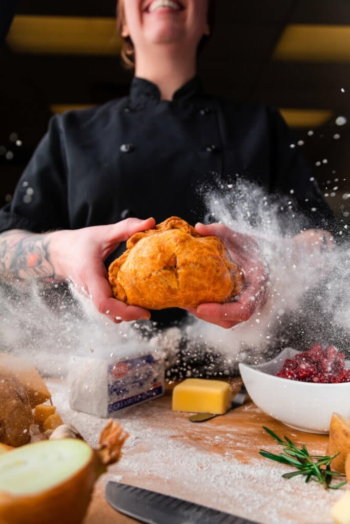 SarahBennetto O'Brian holds hand pie with dishes of ingredients closeby