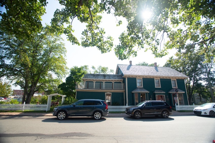 Outside street view of Holman's Heritage Suites, large two storey blue building