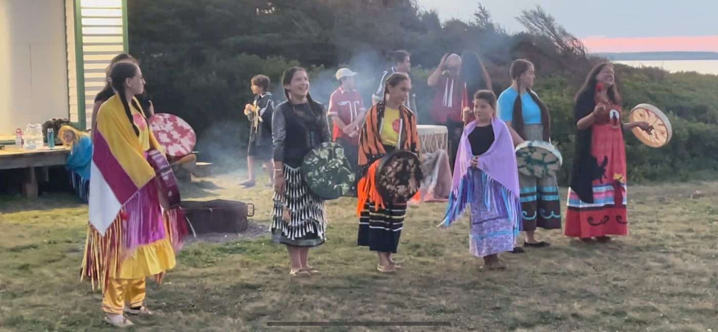 Participants dance and drum at A’Tuken campfire program at Cavendish National Park campground