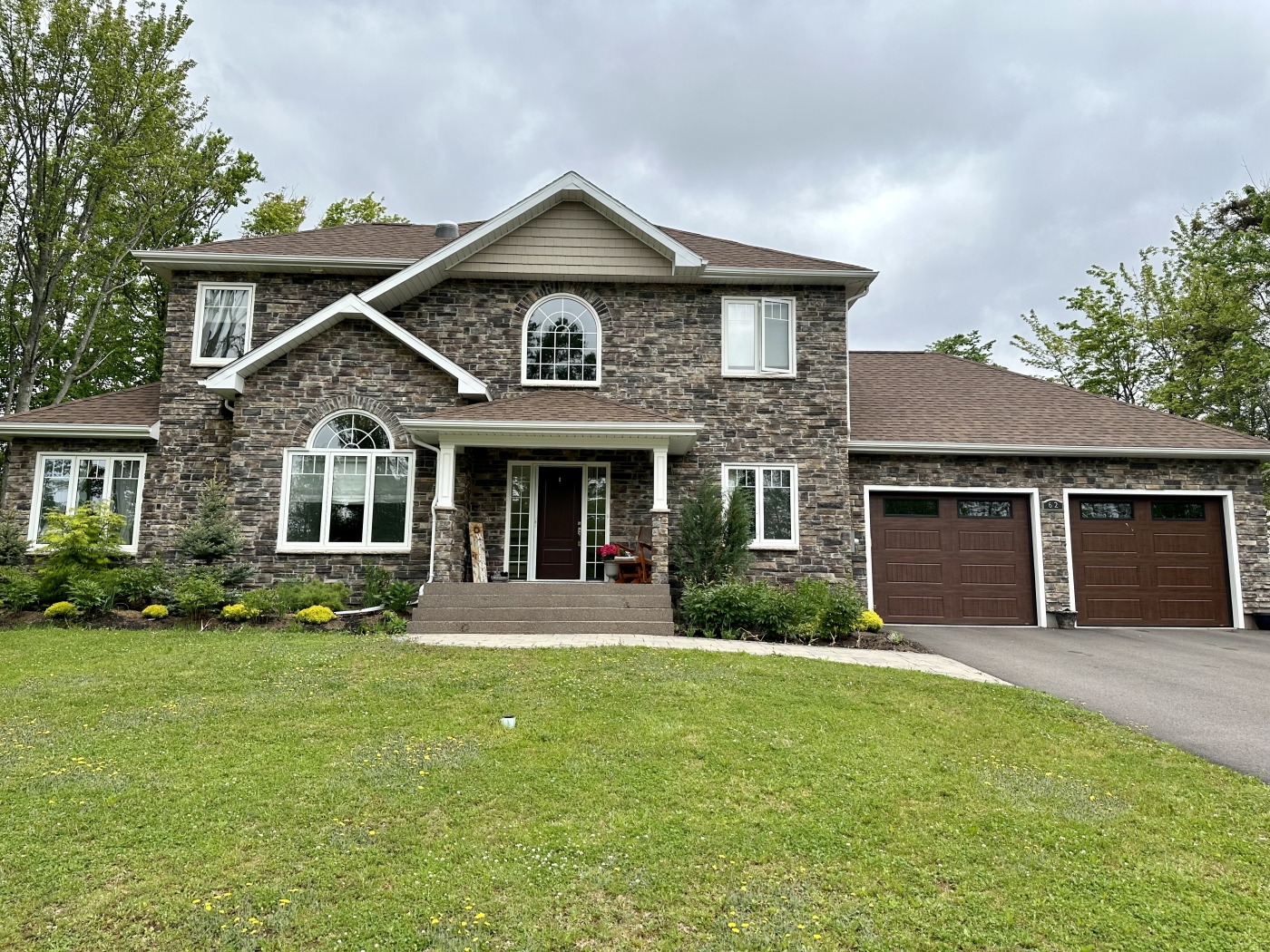 Large two-story home with double garage and stone facade