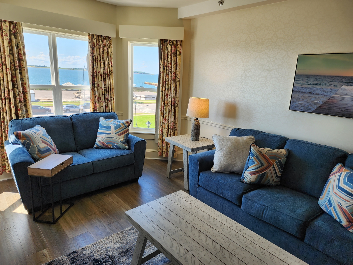 Living area with blue sofa and love seat