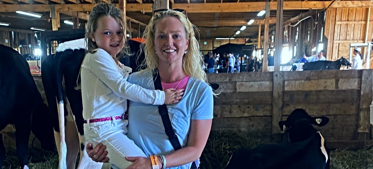 Image of Maria Smith and niece in cow barn