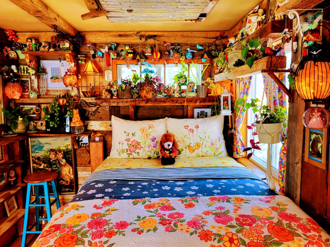 photo of a bedroom with brightly colored decor, lots of wood and decorations