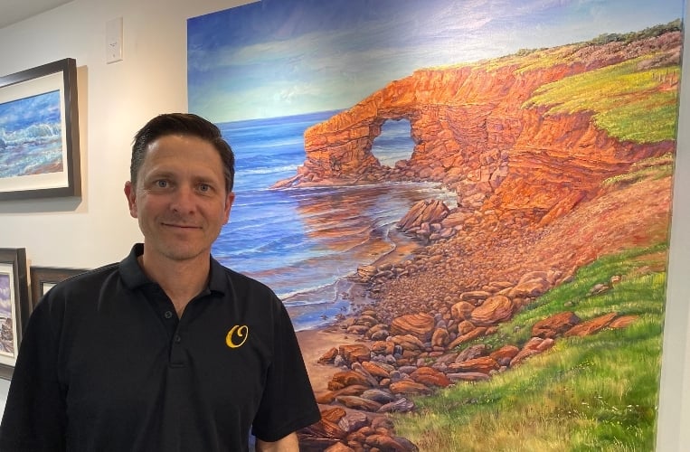 O'Neil PEI Scott O'Neil stands beside one of his paintings in his gallery